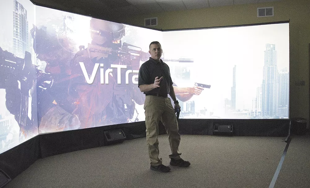 Spokane Police Sgt. Chris Crane introduces officers to several scenarios on the department's interactive training screen. - JACOB JONES