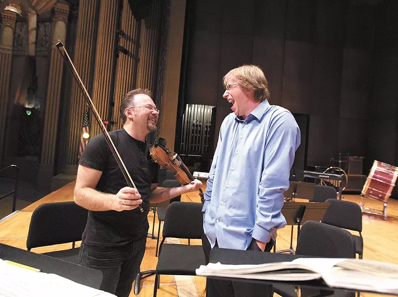 Spokane Symphony concertmaster Mateusz Wolski, left, and Music Director Eckart Preu share a laugh during rehearsals. - YOUNG KWAK