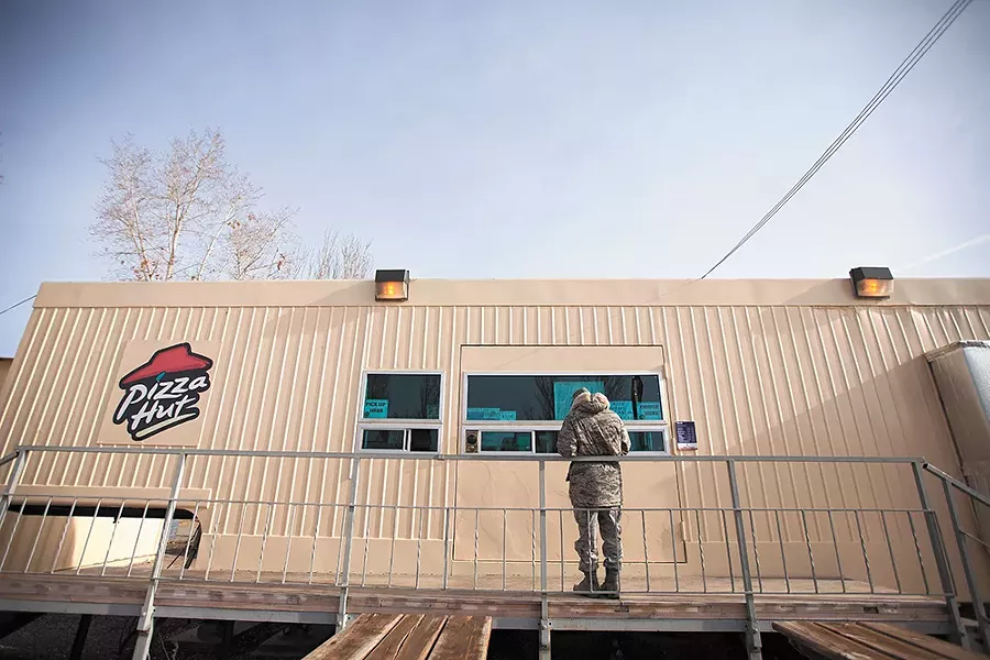 Staff Sgt. Velinzala Wallace picks up food from the Manas Pizza Hut. - YOUNG KWAK