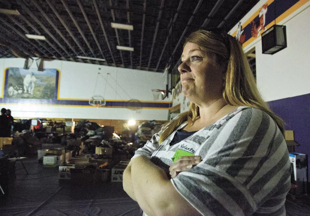 Suzette Ellis, a local relief volunteer, takes stock of the donations streaming into Pateros High School to help displaced residents recover from the fire. - JACOB JONES