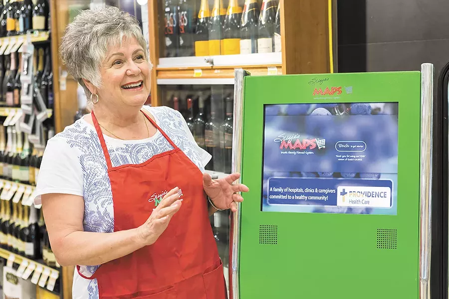 Suzie's Maps founder Suzie Willcox demonstrates how to use the kiosk in the South Hill Rosauers. - STEPHEN SCHLANGE