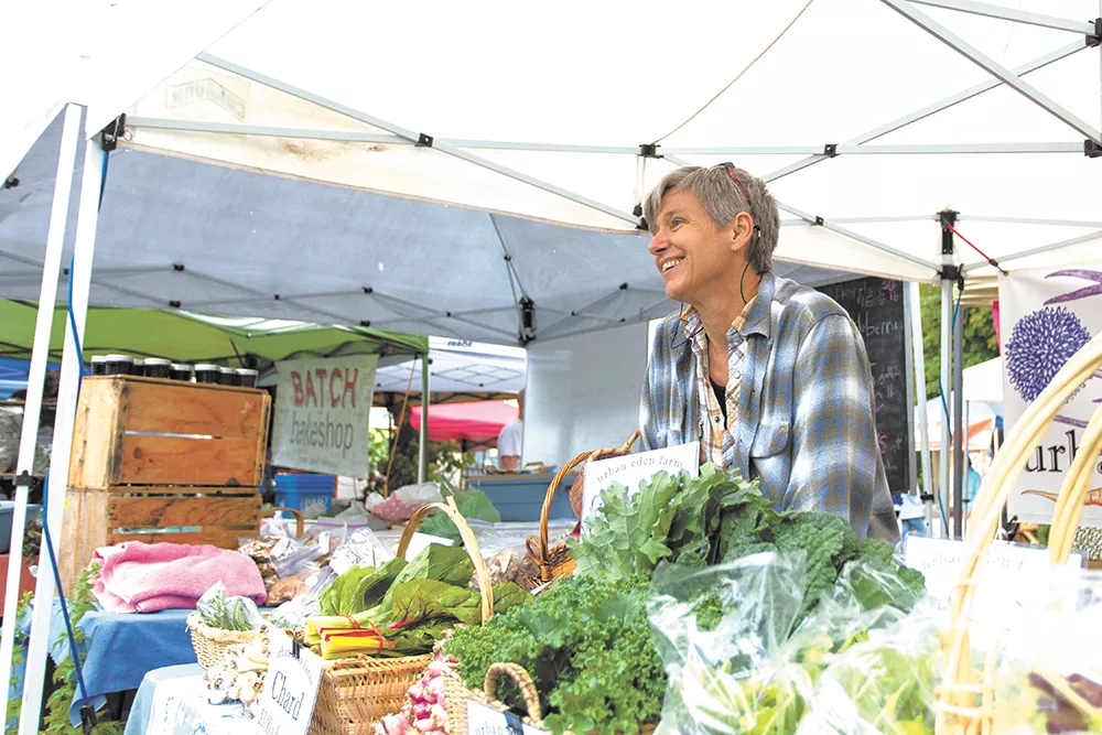 Tarawyn Waters connects with customers at Thursday Market in Spokane’s South Perry District. - YOUNG KWAK