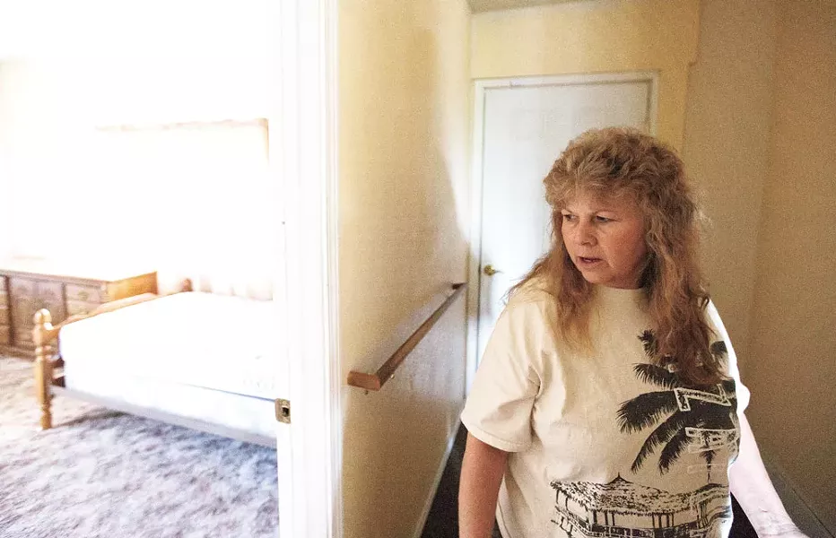 Terri Mayer walks through her empty group home. - YOUNG KWAK
