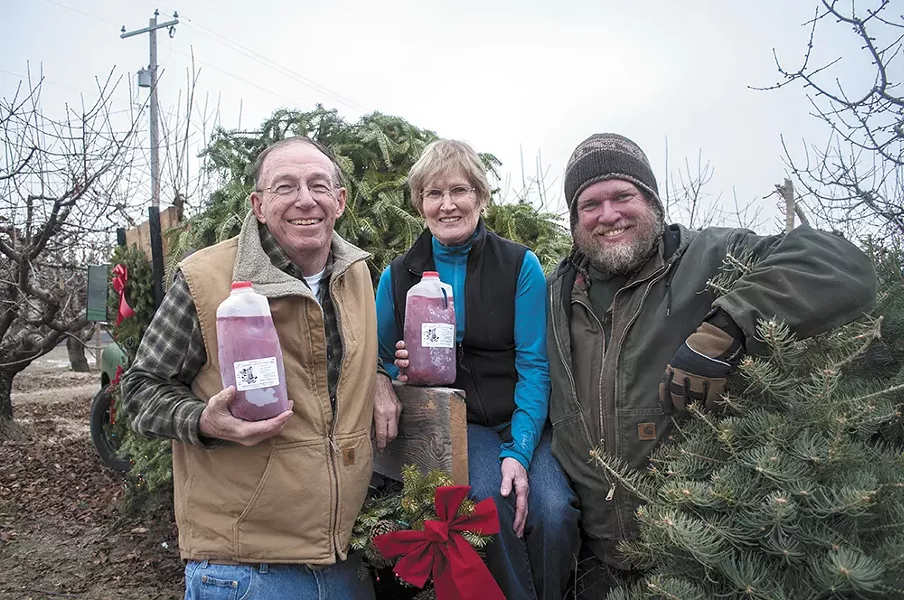 The Hansens — Rod, Karen and Derrick Hansen, from left — have been growing apples on Green Bluff for three decades. - SARAH WURTZ
