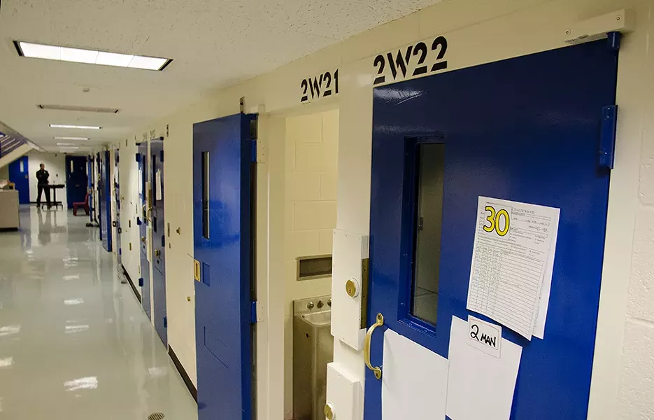 The row of cells used for inmates on “suicide watch” at the Spokane County Jail. The “30” magnet on the cell door indicates the inmate must be checked on every 30 minutes. - JACOB JONES
