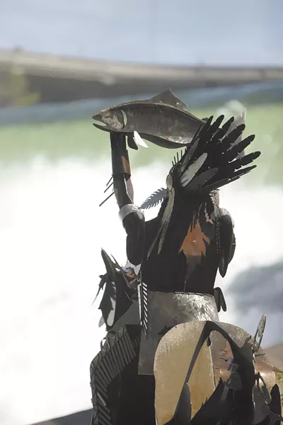 The Salmon Chief, located at Spokane's new Huntington Park along the lower falls of the Spokane River, raises a salmon to bless the river.