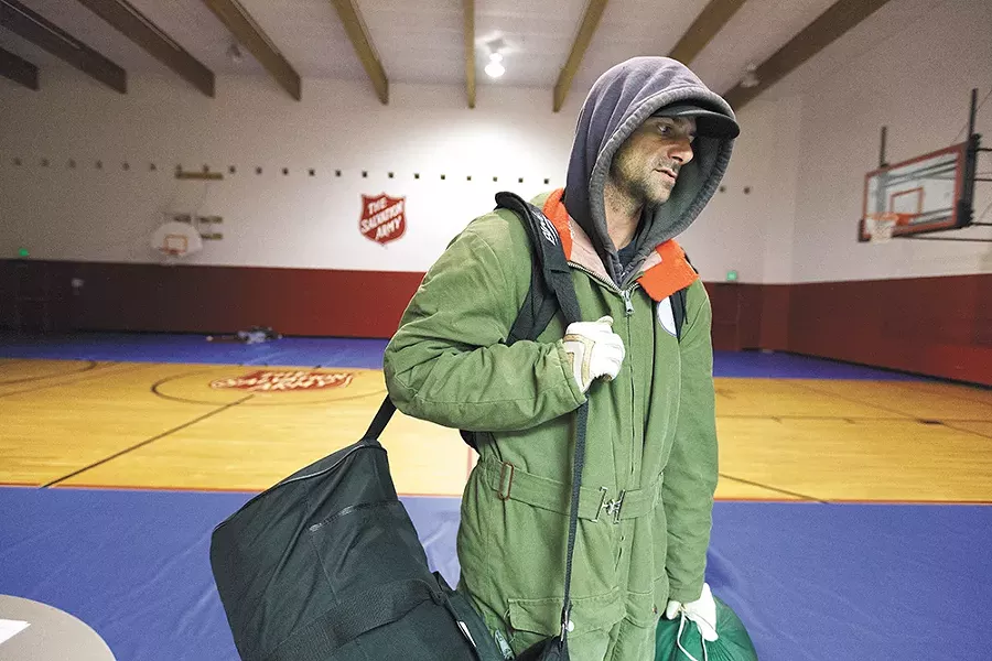 Tim Henry, of Las Vegas, seeks shelter in a local warming center as he makes his way south. - YOUNG KWAK