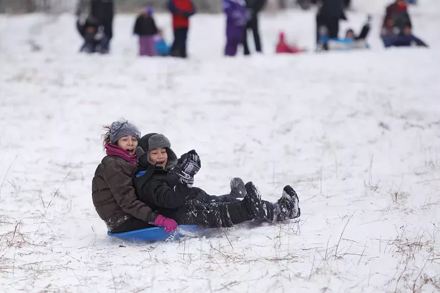 Twelve-year-old Lakaija Dunbar, left, and her 6-year-old brother, Desean, sled at Underhill Park. - YOUNG KWAK
