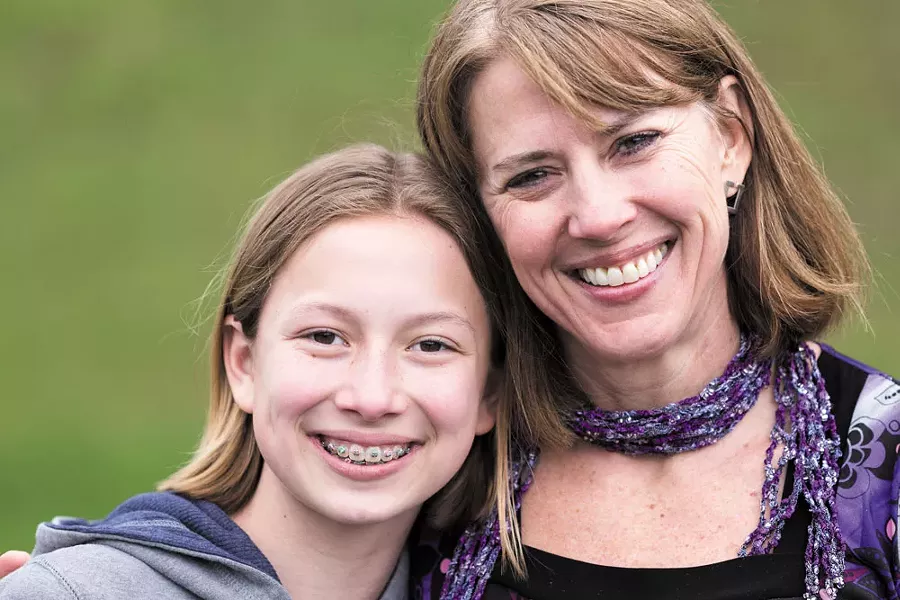 Twyla-Lea Jensen flashes her new smile alongside her daughter Landyn. - STEPHEN SCHLANGE