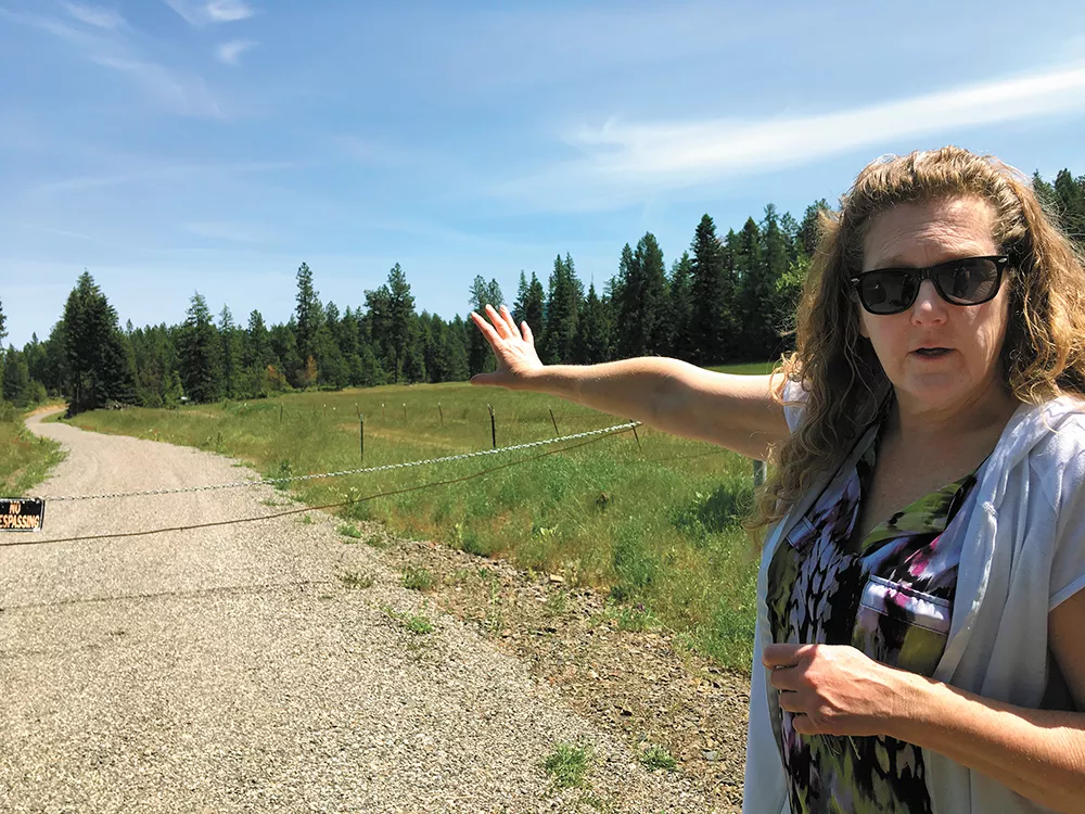 Chris Greenfield stands in front of a road she says never should have been built on her family's property. - SAMANTHA WOHLFEIL PHOTO