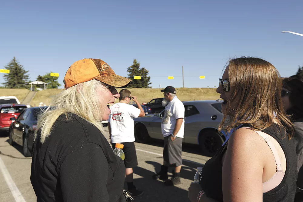 Miss Shifters members Angie Weaver, left, and Jessica Boller compare notes before a race. - YOUNG KWAK