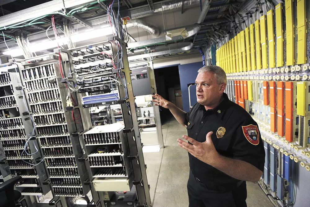 Spokane Fire Chief Brian Schaeffer showcases the innards of the Combined Communications Center — which currently holds multiple dispatch agencies. - YOUNG KWAK
