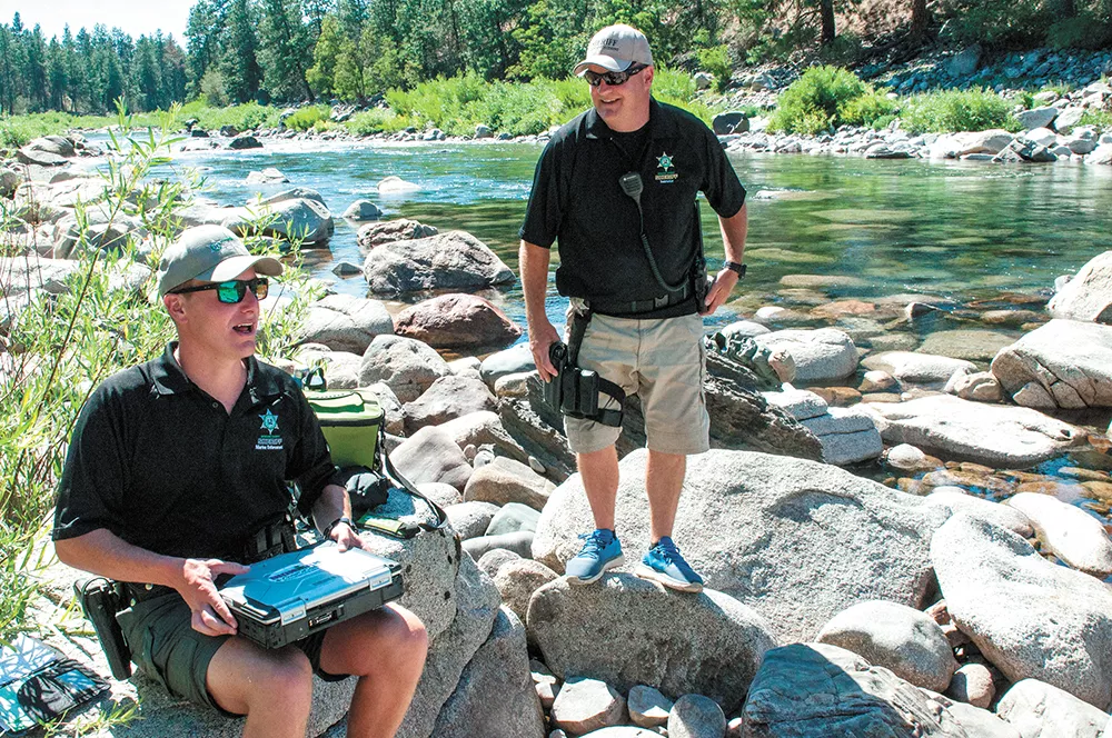 Spokane County Sheriff deputies Brad Humphrey and Jim Ebel conduct life-jacket emphasis patrols on the river last month. - DANIEL WALTERS PHOTO