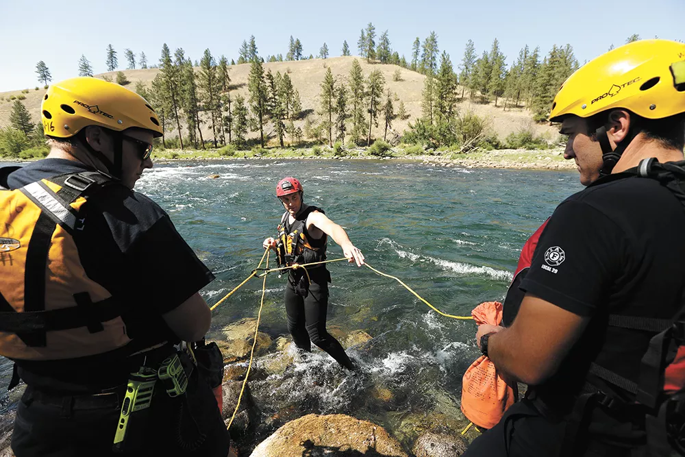 Members of the Spokane Fire Department's swift-water rescue team train with the technical rescue team, which uses ropes to rescue people in hard-to-reach places. - YOUNG KWAK