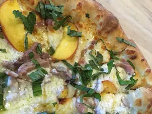 Don't wait to enjoy this popular seasonal pie, topped with fresh Green Bluff peaches. - SOUTH PERRY PIZZA