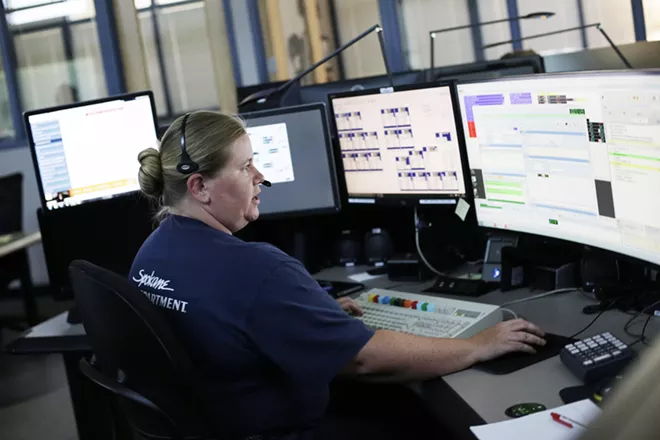 Spokane Fire Communications Specialist Cassidy Haas works on a call at the Fire Department's Combined Communications Building in Spokane. - YOUNG KWAK