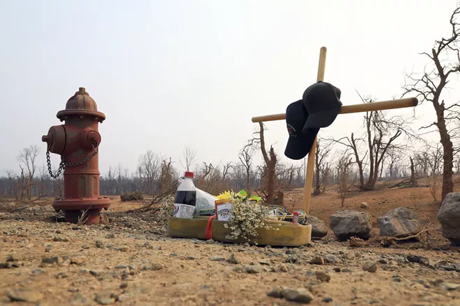 A makeshift memorial honors Jeremy Stoke, a Redding firefighter who died, in a burned area in Redding, Calif., Aug. 1, 2018. Officials said the Carr Fire was one of 17 major fires across California that have consumed more than 450,000 acres. Gov. Jerry Brown called it the “new normal.” - JIM WILSON/THE NEW YORK TIMES