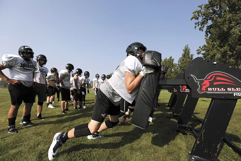 Each season, coaches teach Lewis and Clark High School football players how to avoid head injuries. - YOUNG KWAK