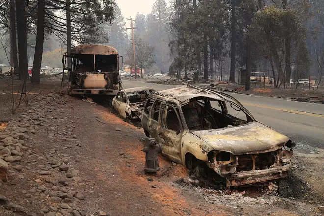 A line of vehicles that were abandoned along the road in Paradise, Calif., Nov. 11, 2018. Of the 23 people known on Sunday to have been killed by the fire in Paradise, six had died in their cars. - JIM WILSON/THE NEW YORK TIMES