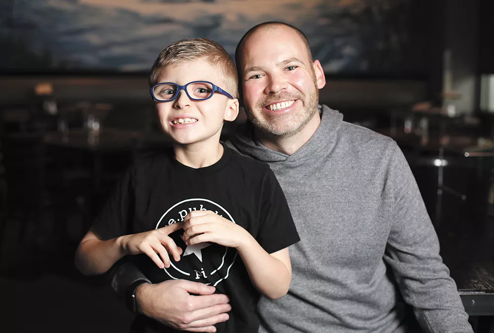 Flying Goat co-owner Jonathan Sweatt with his 7-year-old nephew Charlie, who inspired Sweatt to support the Spokane Guilds' School. - YOUNG KWAK