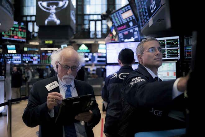 Traders work on the floor of the New York Stock Exchange on Wednesday, Aug. 22, 2018.  By one measure, stocks crossed a major threshold on Wednesday. But the financial gains of the decade-long run have been concentrated among the already wealthy. - JOHN TAGGART/THE NEW YORK TIMES