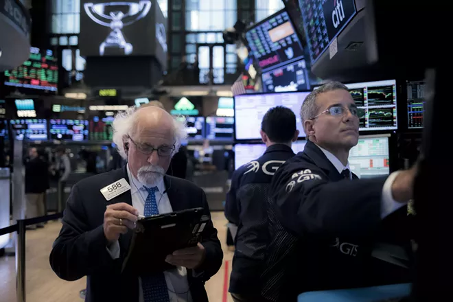 Traders work on the floor of the New York Stock Exchange on Wednesday, Aug. 22, 2018. By one measure, stocks crossed a major threshold on Wednesday. But the financial gains of the decade-long run have been concentrated among the already wealthy. - JOHN TAGGART/THE NEW YORK TIMES