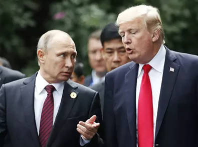 President Donald Trump and President Vladimir Putin of Russia converse as leaders participating in the APEC summit took a group photo, in Danang, Vietnam, in 2017. - JORGE SILVA/POOL VIA THE NEW YORK TIMES
