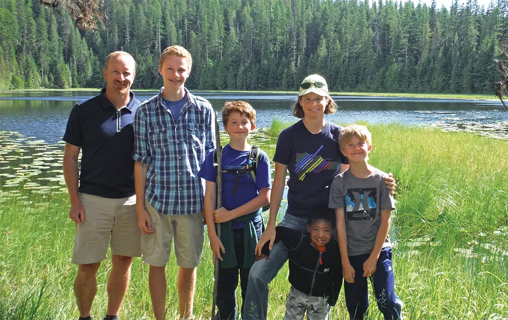 "We thought we need to share this information we gained from going to the parks and compile a resource that would be good for parents," says Abby McAllister, pictured with her husband Harley and four of their kids at Glacier National Park. - ABBY MCALLISTER PHOTO