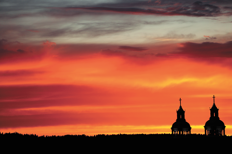 The Cathedral of Our Lady of Lourdes silhouetted against a Spokane sunset. Under Bishops Daly and Cupich, the Diocese of Spokane has had to climb back from the bankruptcy and abuse scandals that defined the tenure of their predecessor, Bishop William Skylstad. - YOUNG KWAK PHOTO
