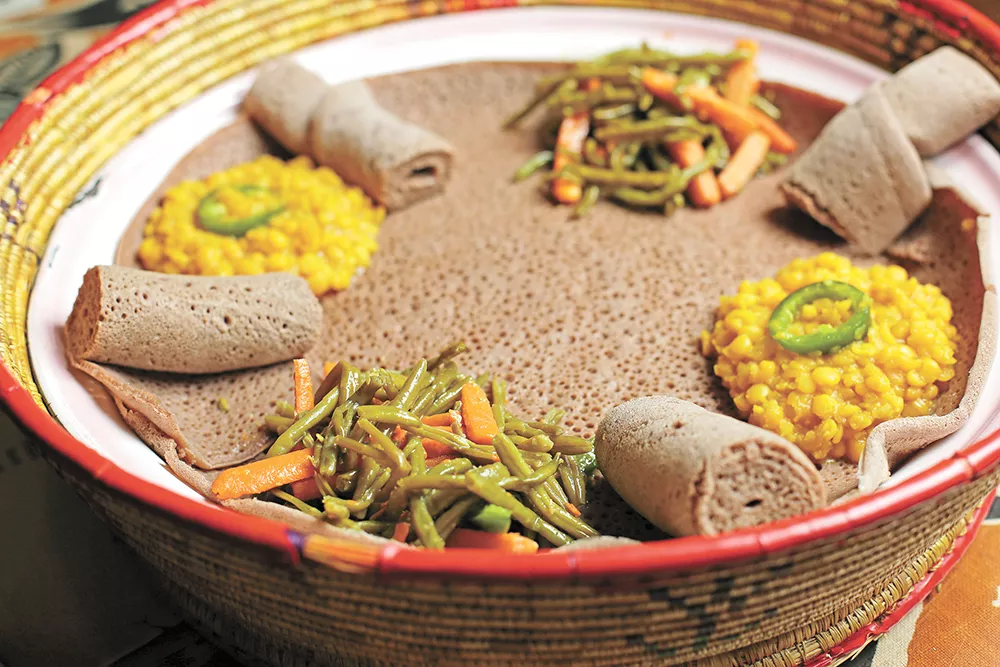 The bread is called injera and you'll want plenty of it to scoop up all the yummy flavors at Queen of Sheba. - YOUNG KWAK PHOTO