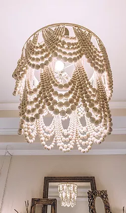 Inspired by a Pottery Barn fixture, Shannon Morscheck created her own wood-bead chandelier. - ERICK DOXEY PHOTO