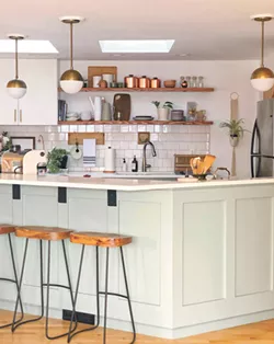 Removing cabinets above the sink made room for functional open shelving to accommodate everyday items. - GIANNA CAPUTO PHOTO