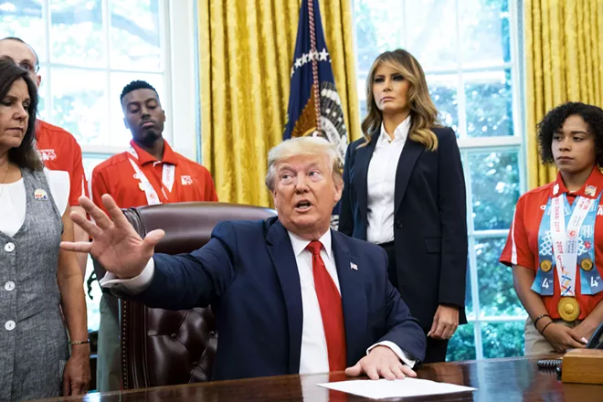 President Donald Trump speaks to reporters while meeting with U.S. Special Olympics athletes and staff in the Oval Office, at the White House in Washington, July 18, 2019. Trump on Thursday disavowed the “send her back” chant that broke out at his re-election rally Wednesday night when he railed against a Somali-born congresswoman, saying he “was not happy” with the chant and claimed that he had tried to cut it off, a claim contradicted by video of the event. Second from right is first lady Melania Trump. - DOUG MILLS/THE NEW YORK TIMES