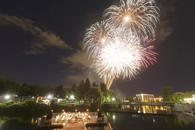 The Royal Band, conducted b David Dutton, performs George Frideric Handel's "Musick for the Royal Fireworks, 1749, as fireworks are set off over Riverfront Park, during the Royal Fireworks Concert, Sunday, July 26, 2015, in Spokane. - YOUNG KWAK PHOTO