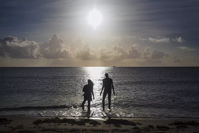People wade into the Atlantic Ocean in Miami Beach, Fla., Sept. 1, 2019. Earth’s oceans are under severe strain from climate change, a major new United Nations report issued on Sept. 25 warns, threatening everything from the ability to harvest seafood to the well-being of hundreds of millions of people living along the coasts. - SCOTT MCINTYRE/THE NEW YORK TIMES