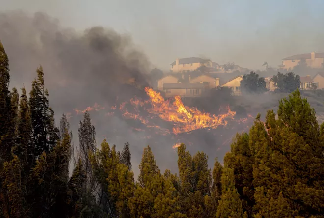The Saddleridge fire burns in northwest Los Angeles on Friday, Oct. 11, 2019. A fire tore through Southern California overnight into Friday, forcing mandatory evacuations for more than 100,000 people and setting dozens of homes ablaze, just as power was being restored to hundreds of thousands of Northern Californians. - KYLE GRILLOT/THE NEW YORK TIMES