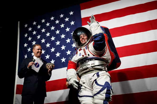 NASA Administrator Jim Bridenstine introduces NASA advance space suit engineer Kristine Davis as she demonstrates the prototype exploration extravehicular mobility unit at NASA Headquarters in Washington on Tuesday, Oct. 15, 2019. The mobility of the suit allowed her to pick a rock and hand it to Bridenstine. - TING SHEN/THE NEW YORK TIMES