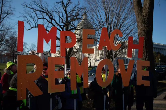 People rally in support of impeaching President Donald Trump, at the Capitol in Washington on Wednesday morning, Dec. 18, 2019. The House of Representatives convened on Wednesday to debate whether to impeach the president for the third time in American history as Democrats bring forward two articles of impeachment charging President Donald Trump with abuse of power and obstruction of Congress. - ALYSSA SCHUKAR/THE NEW YORK TIMES