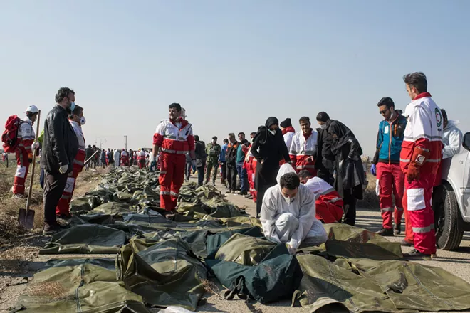 Bodies lie covered near the site of the Ukraine International Airlines crash on the outskirts of Tehran on Wednesday, Jan. 8, 2020. A Ukrainian Boeing 737-800 carrying at least 170 people Wednesday crashed shortly after takeoff from Tehran, killing everyone on board, according to the Iranian state news media. - ARASH KHAMOOSHI/THE NEW YORK TIMES