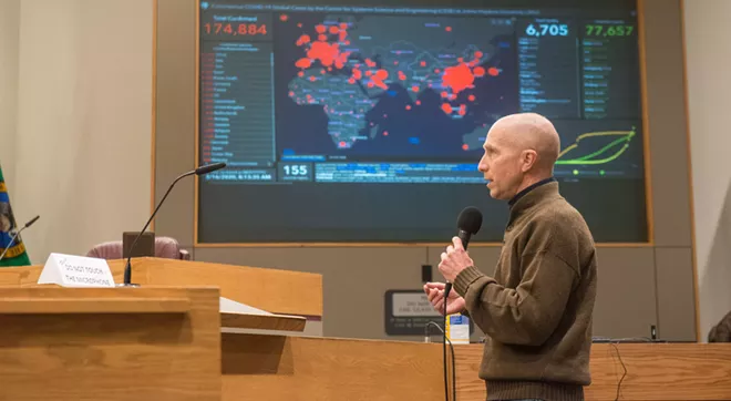 Spokane County Health Officer Bob Lutz stands in front of an extremely foreboding map - DANIEL WALTERS PHOTO
