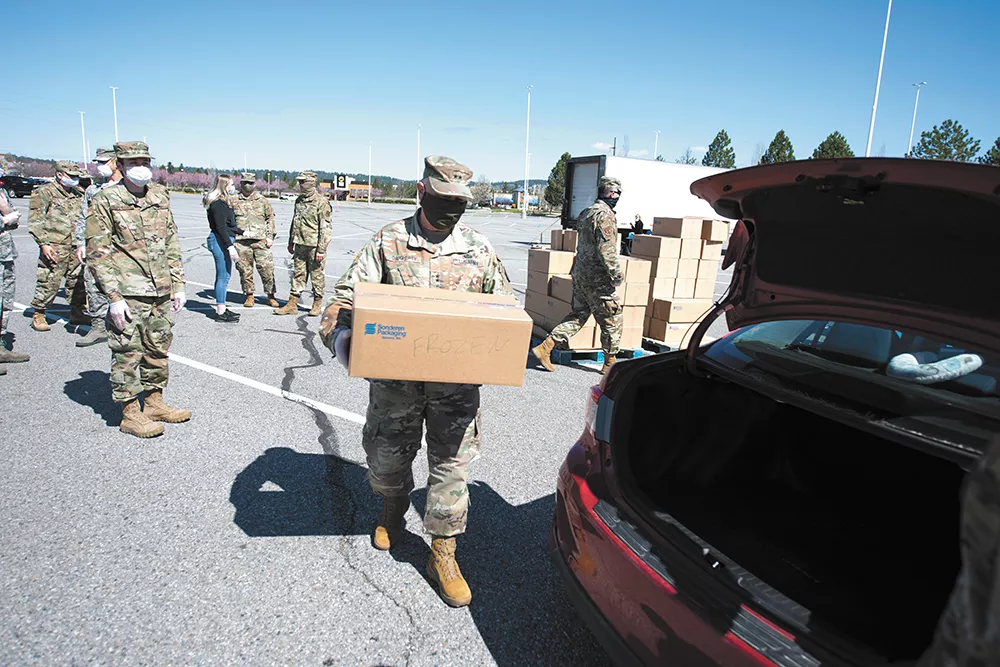 Members of the Washington National Guard distribute food from Second Harvest Food Bank on April 16. - MICHAEL BROWN/WASHINGTON NATIONAL GUARD PHOTO