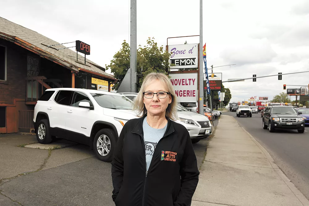Kim Arrotta, co-owner of Northtown Auto Sales, is frustrated that a next-door business, a sex shop, has remained open throughout the shutdown. - YOUNG KWAK PHOTO