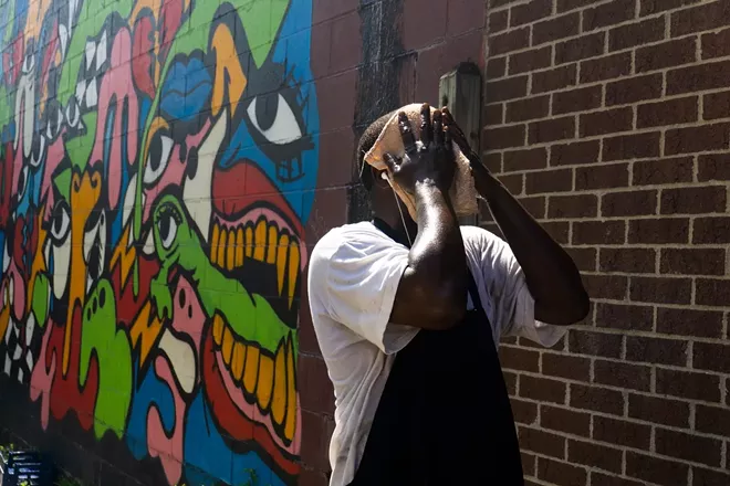 Antjuan Durand, a chef, tries to cool off while grilling at Bert's Marketplace in Detroit, July 20, 2019. Hotter than normal temperatures are expected across almost all of the United States into September, government researchers said. - BRITTANY GREESON/THE NEW YORK TIMES