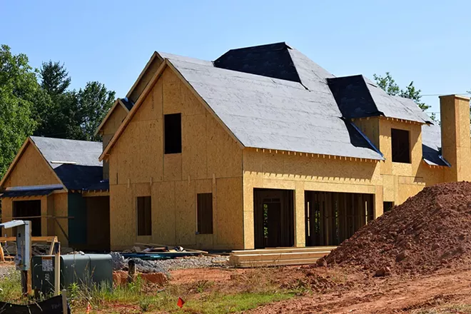 Home builders still have to follow a raft of coronavirus safety rules, including keeping 6 feet apart and wearing masks and goggles.