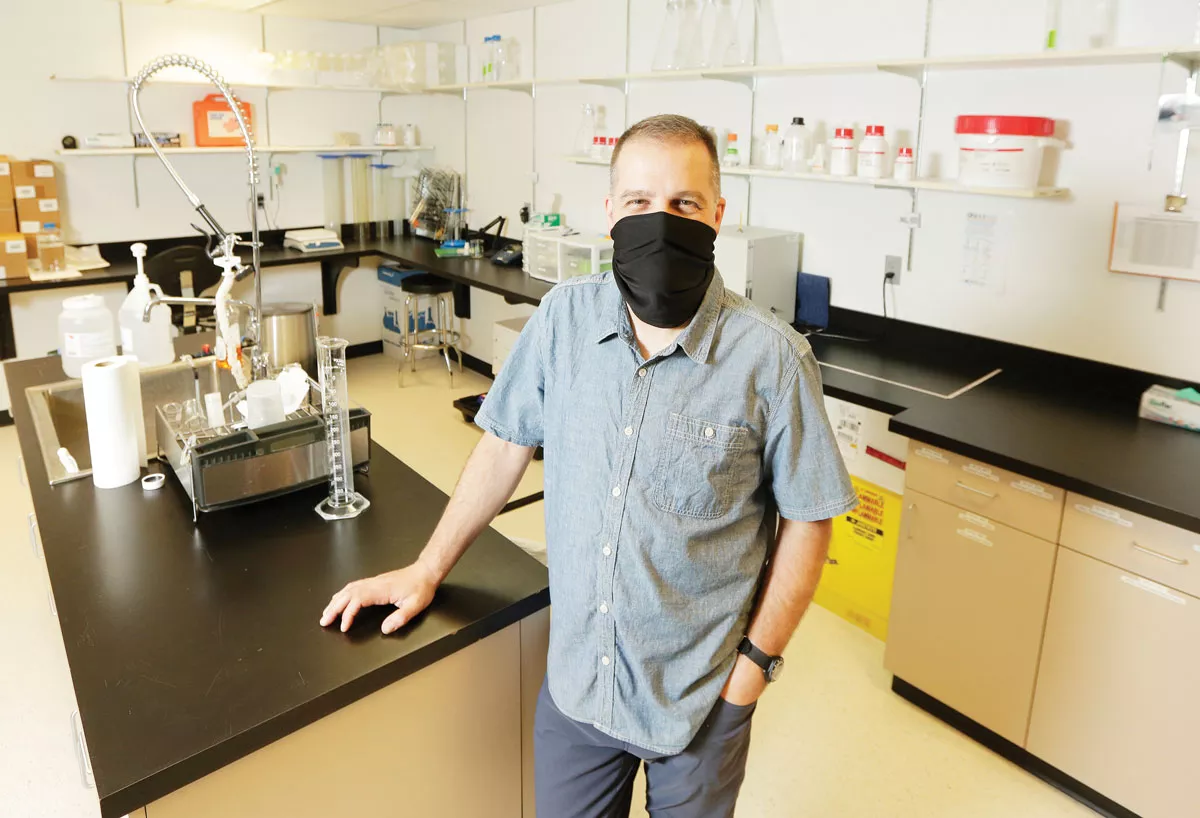 At GenPrime's Spokane lab, Buck Somes says the company's Reader offers improved accuracy in reading and recording coronavirus test results.|young kwak photo