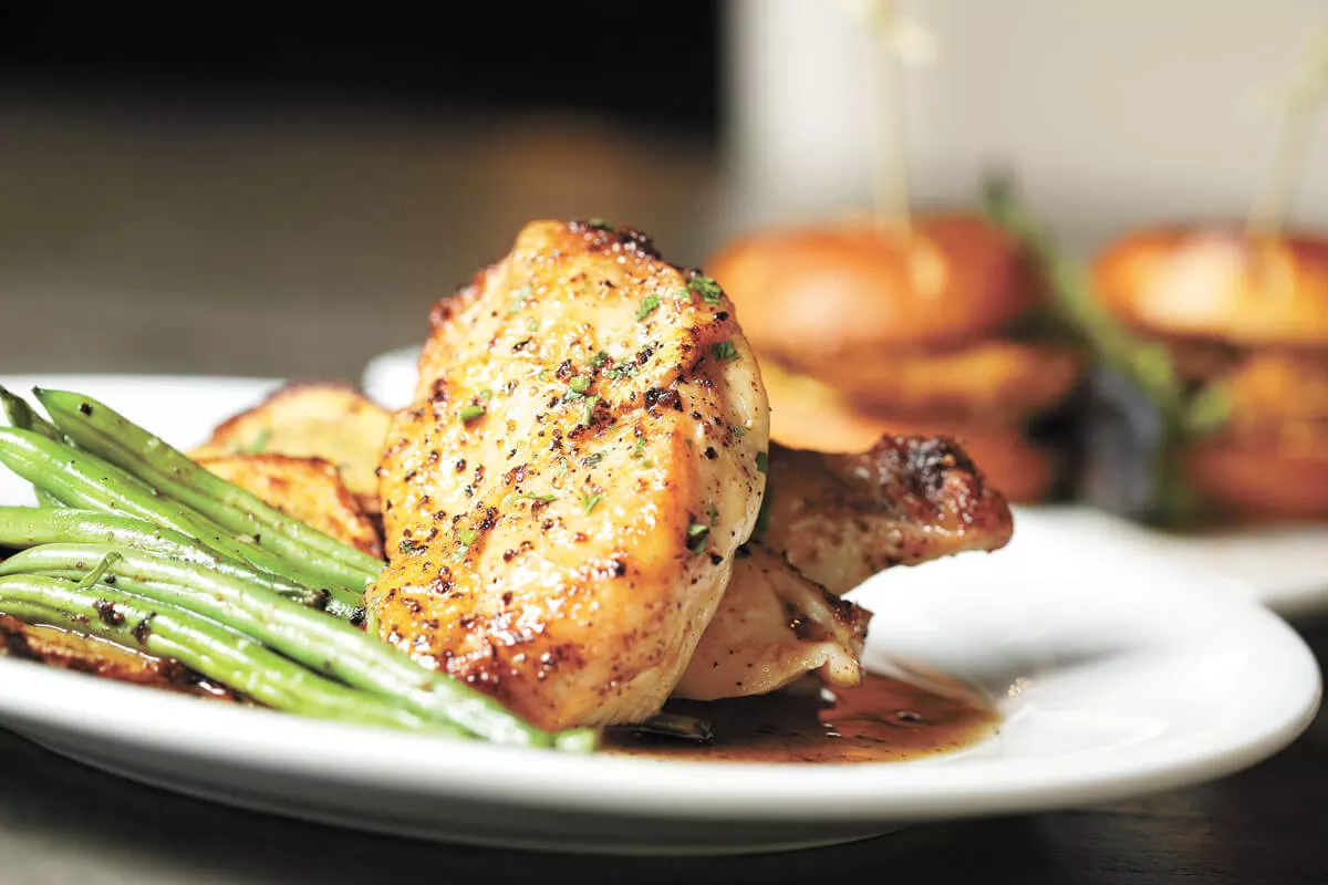 Chicken piquant at Magnolia American Brasserie offers "simple, classic French country cooking." - YOUNG KWAK PHOTO