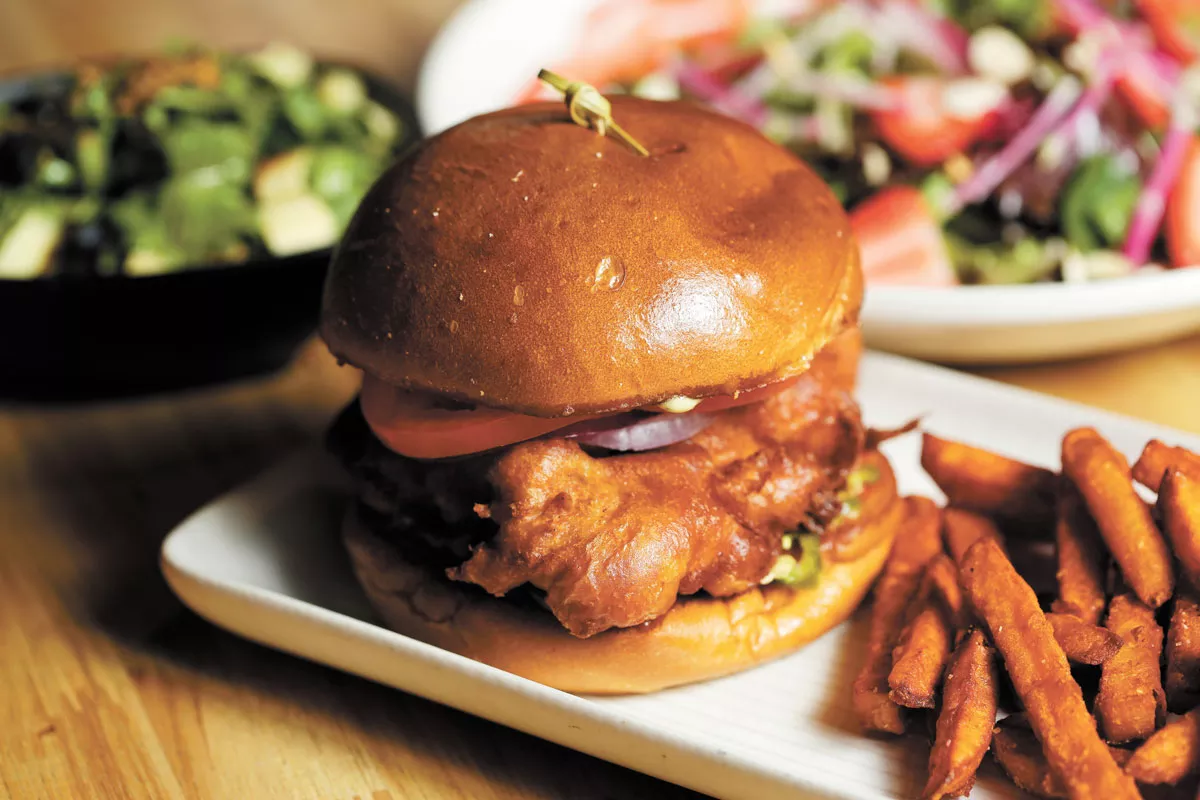 The waffle chicken sandwich, shown here with a side of sweet potato fries, is an early favorite at Bark, A Rescue Pub. - YOUNG KWAK PHOTO