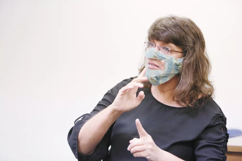 Interpreter Caroline Allen wears a clear face mask while using sign language to translate at Washington Advocates of Deaf & Hard of Hearing. - YOUNG KWAK PHOTO
