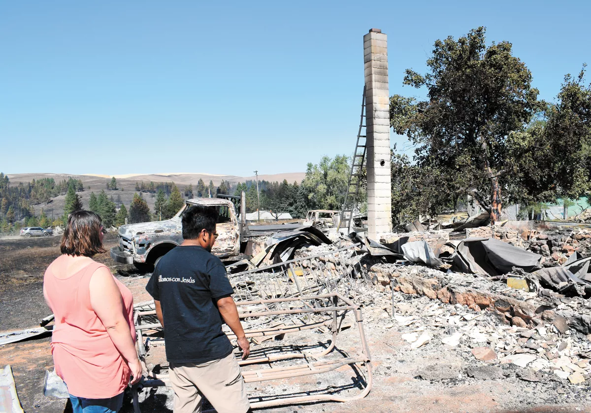 Alfredo and Maria Castillo search for their dog, Toto, in the remains of their house in Malden. - WILSON CRISCIONE PHOTO