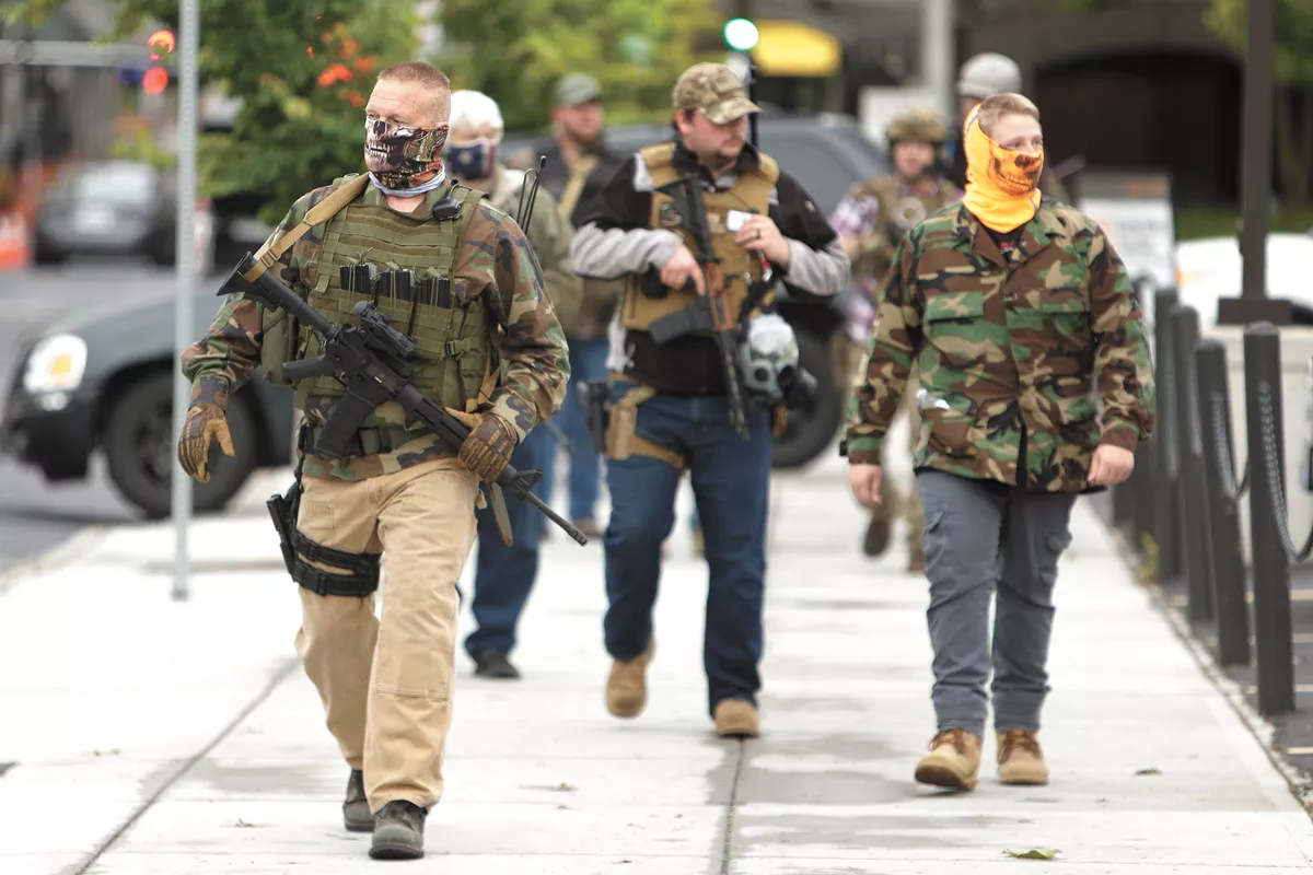 Self-identifying militia members openly carried firearms in downtown Spokane this spring. - YOUNG KWAK PHOTO